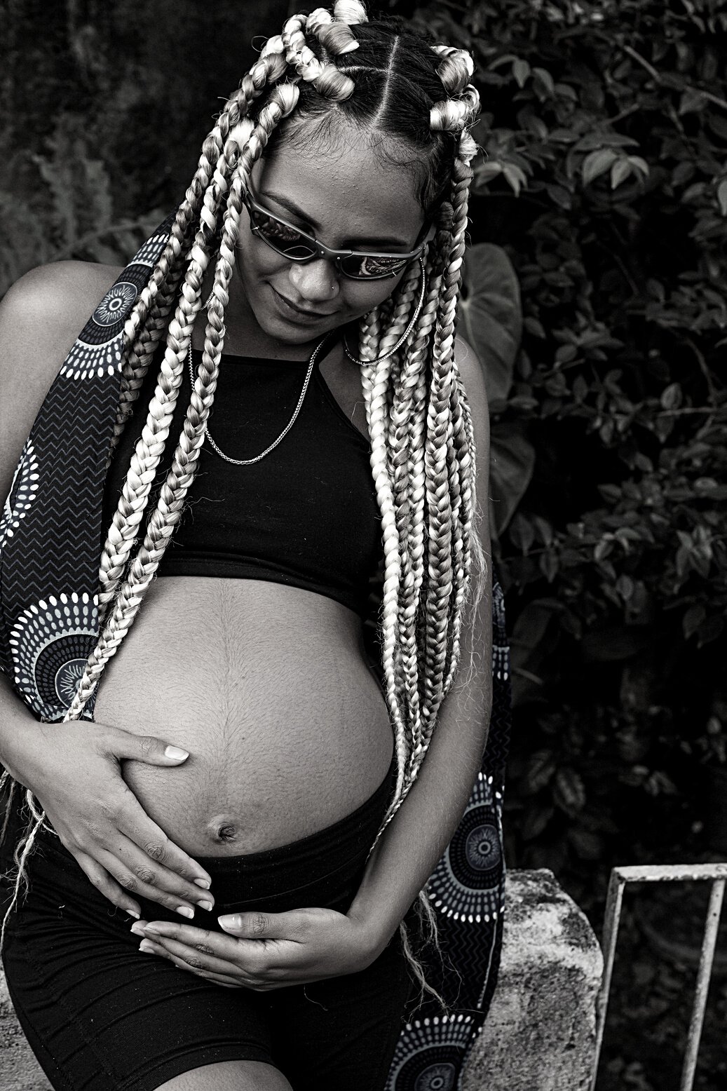 Pregnant black woman touching belly